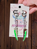 Adorrible two-part bloody knife earrings with detailed silver-tone blades and blood-red accents, stylish and edgy jewelry.