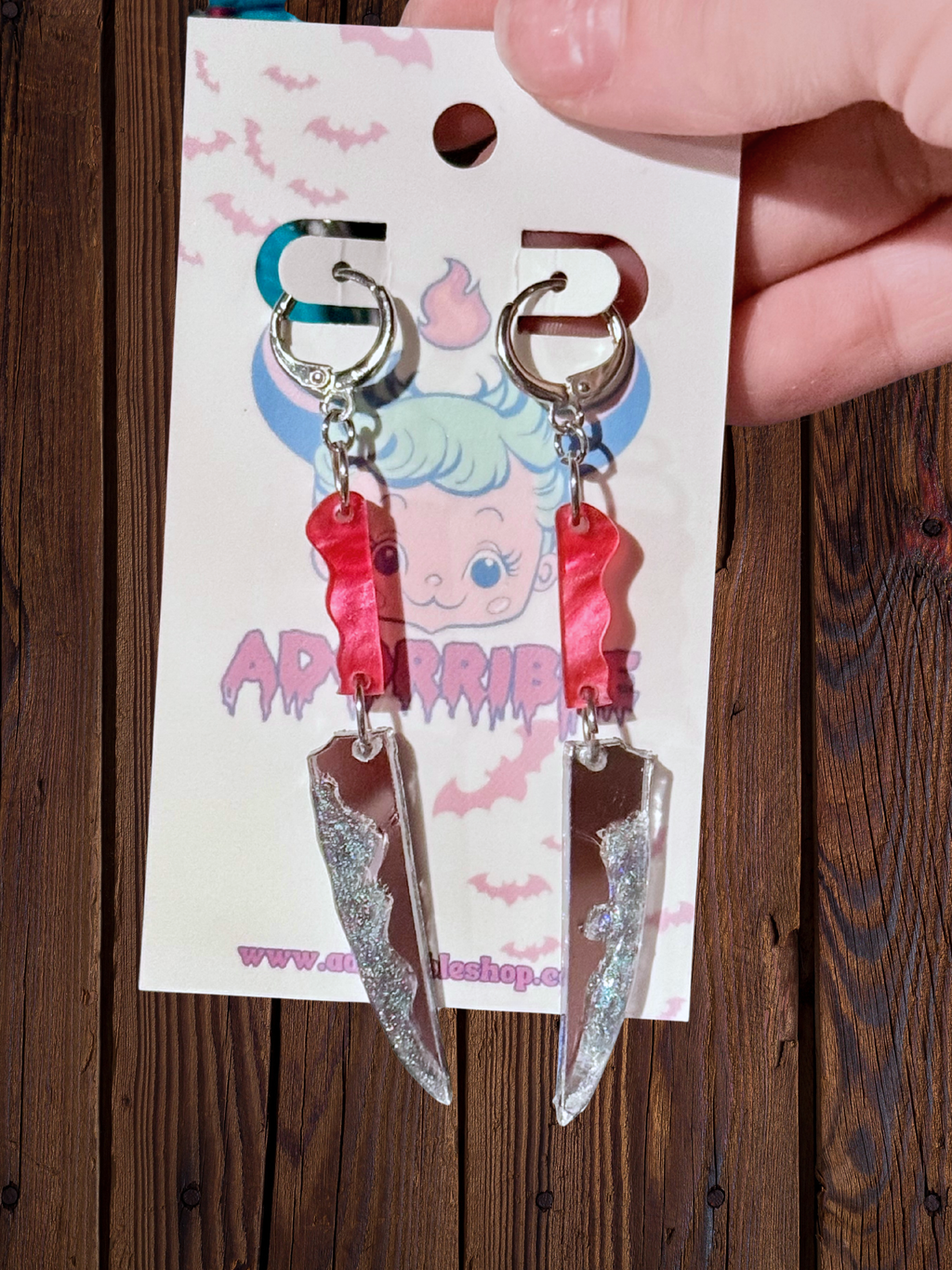 Adorrible two-part bloody knife earrings featuring realistic dagger design with blood-splattered details on silver-toned metal.
