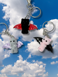 Cute cat keychain with delicate wing design, perfect for collectors and animal lovers