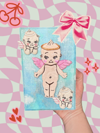 Hand-painted Kewpie wooden boxes by Adorrible with colorful, whimsical designs, showcasing intricate artwork on smooth wooden surfaces.