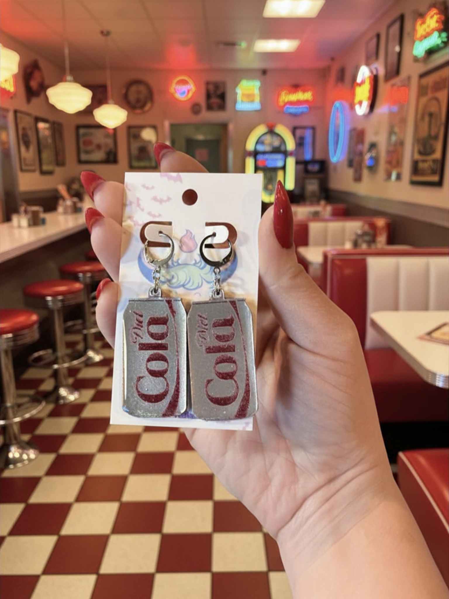 Adorrible Diet Cola earrings featuring small, realistic cola bottle charm earrings on a silver hook.