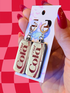 Adorrible Diet Cola earrings featuring small, detailed bottle-shaped jewelry with colorful label design.