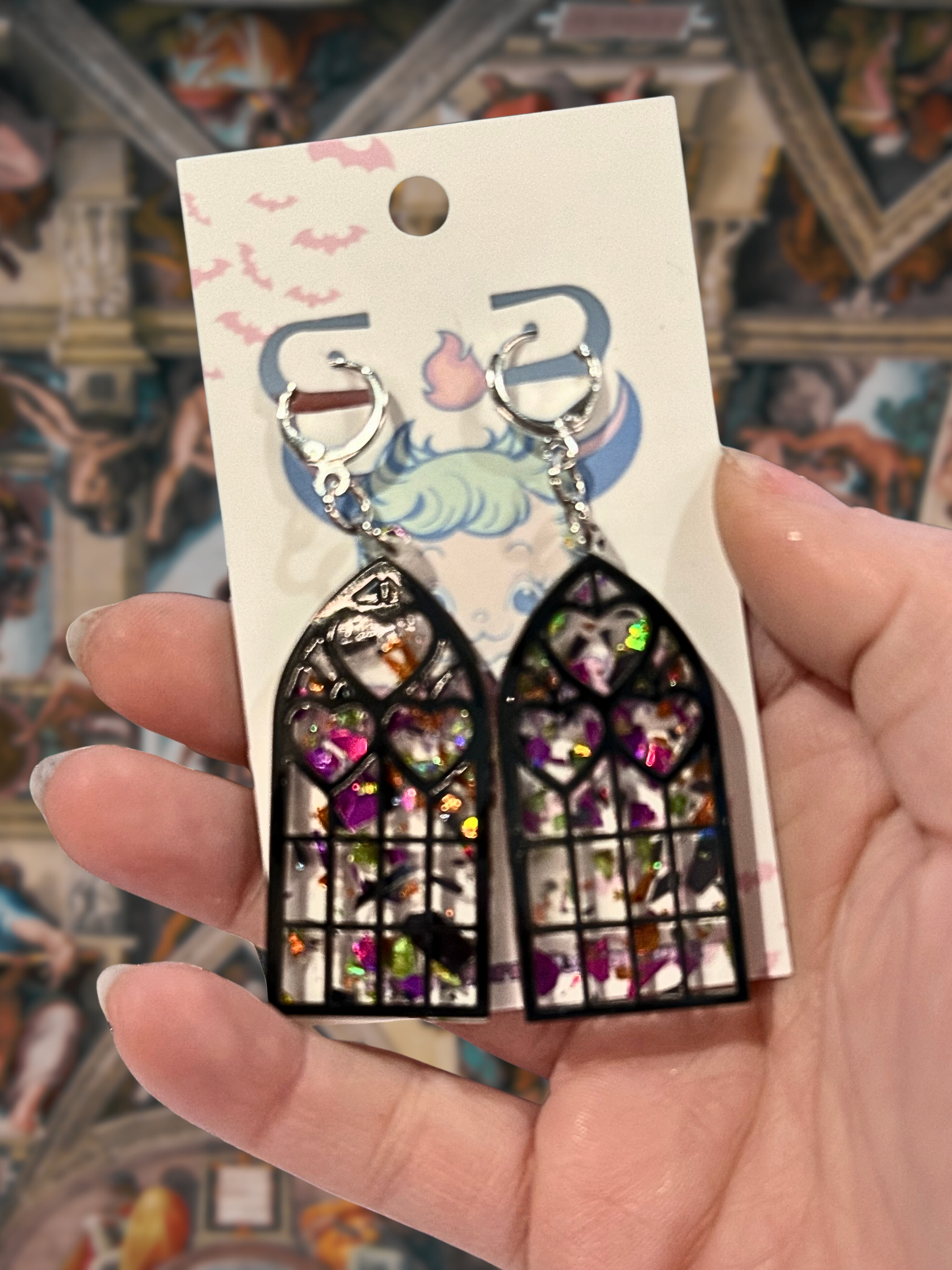 Adorrible Cathedral of Love earrings featuring intricate heart-shaped design in silver, hanging jewelry with detailed craftsmanship.
