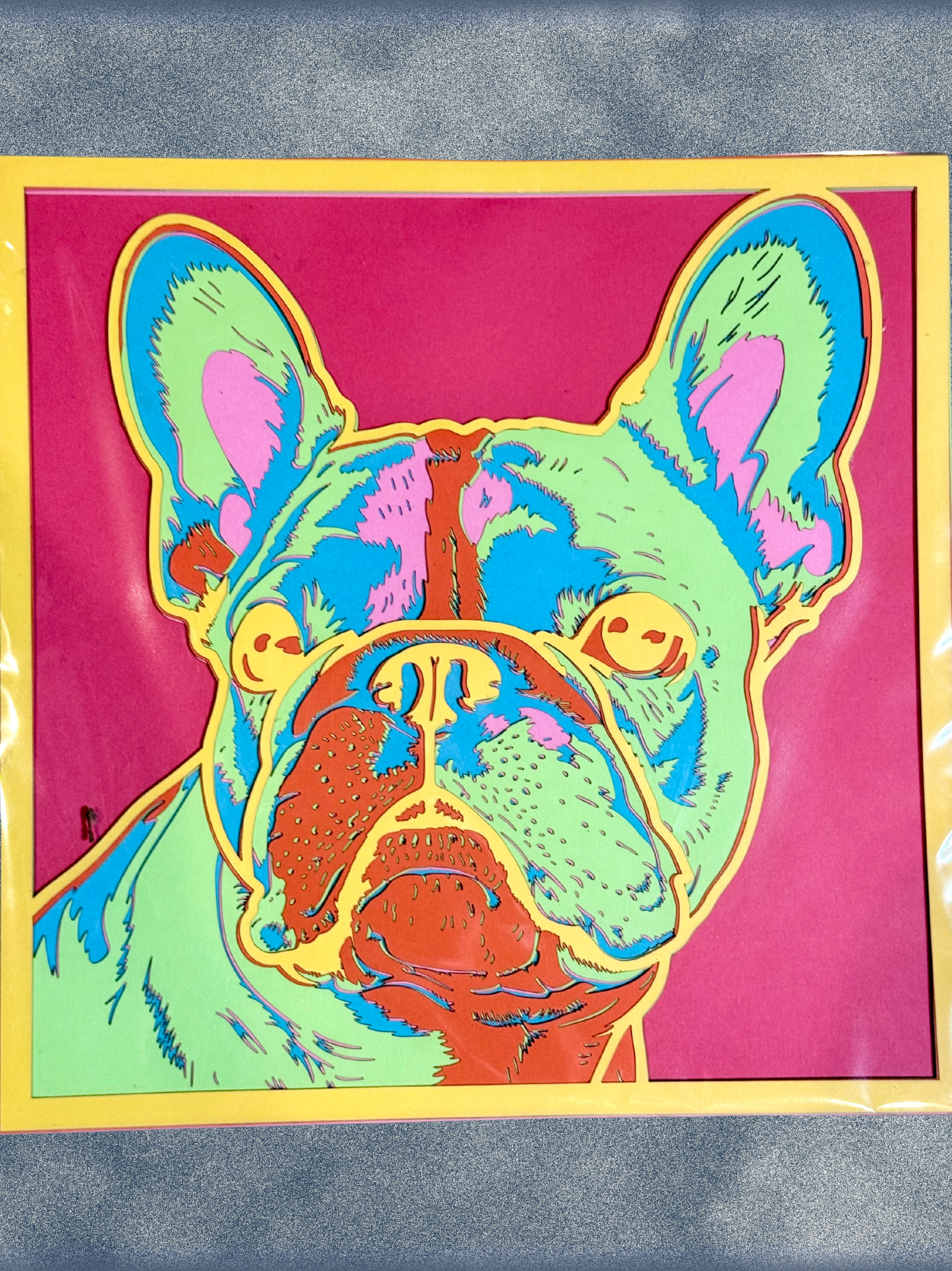 Adorrible dog layered paper 3D art showcasing a detailed, colorful paper craft of a dog's face with intricate layered design.