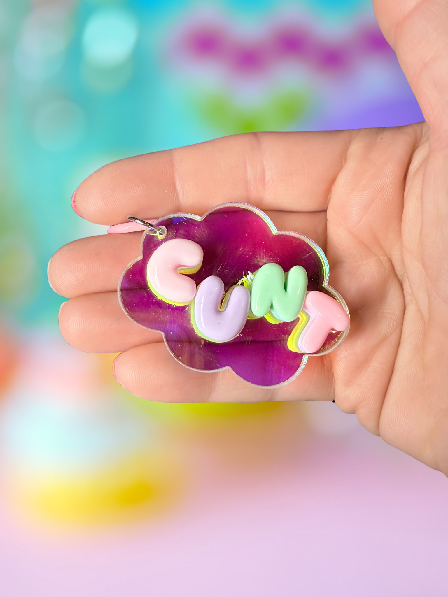 Iridescent cloud keychain with bubble letter design from Adorrible, featuring shiny, colorful cloud-shaped charm on a metal keyring.