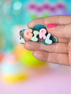 Iridescent cloud-shaped Bubble Letter keychain by Adorrible with colorful bubble letters on a clear cloud charm.