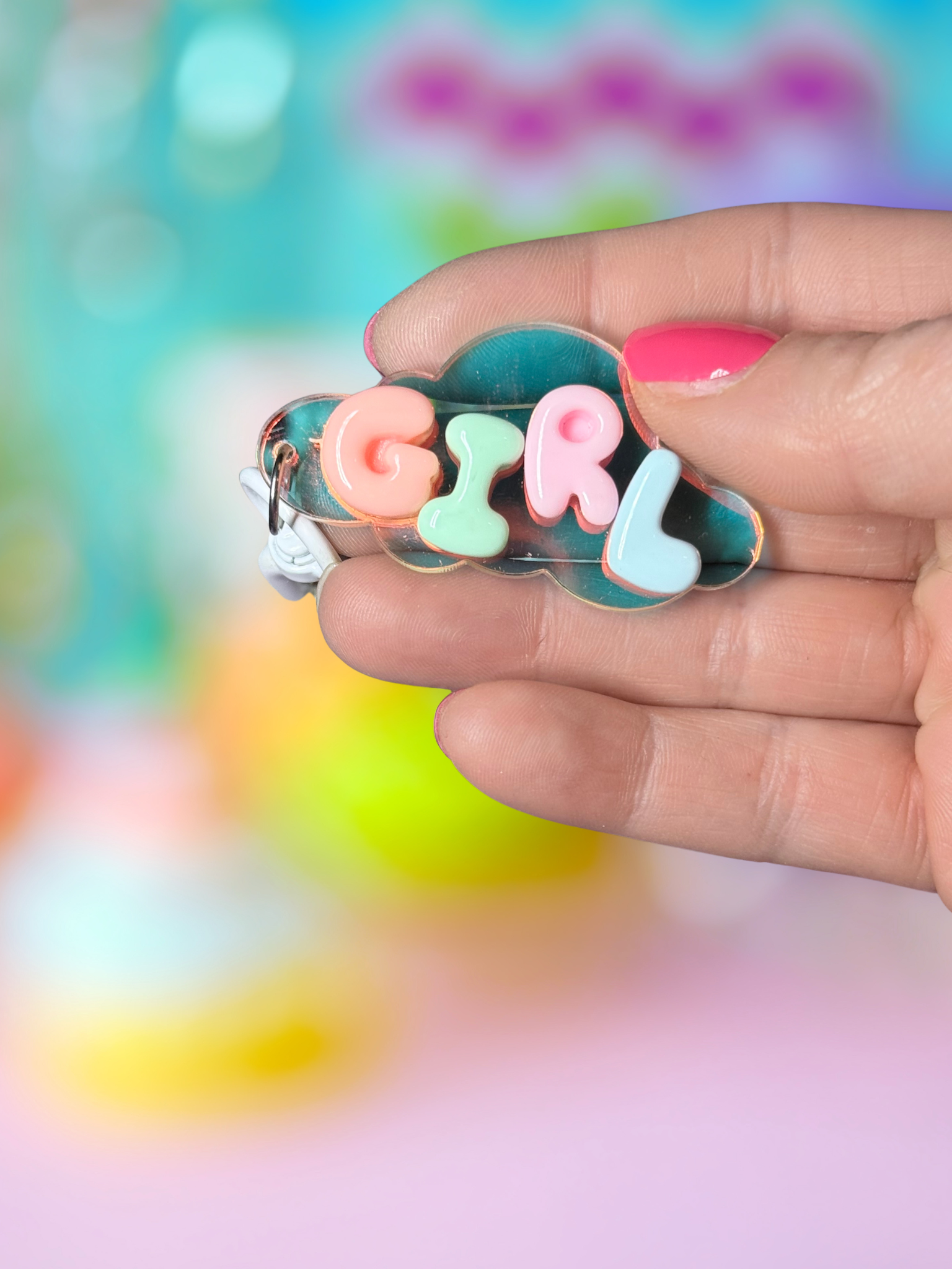 Iridescent cloud-shaped Bubble Letter keychain by Adorrible with colorful bubble letters on a clear cloud charm.