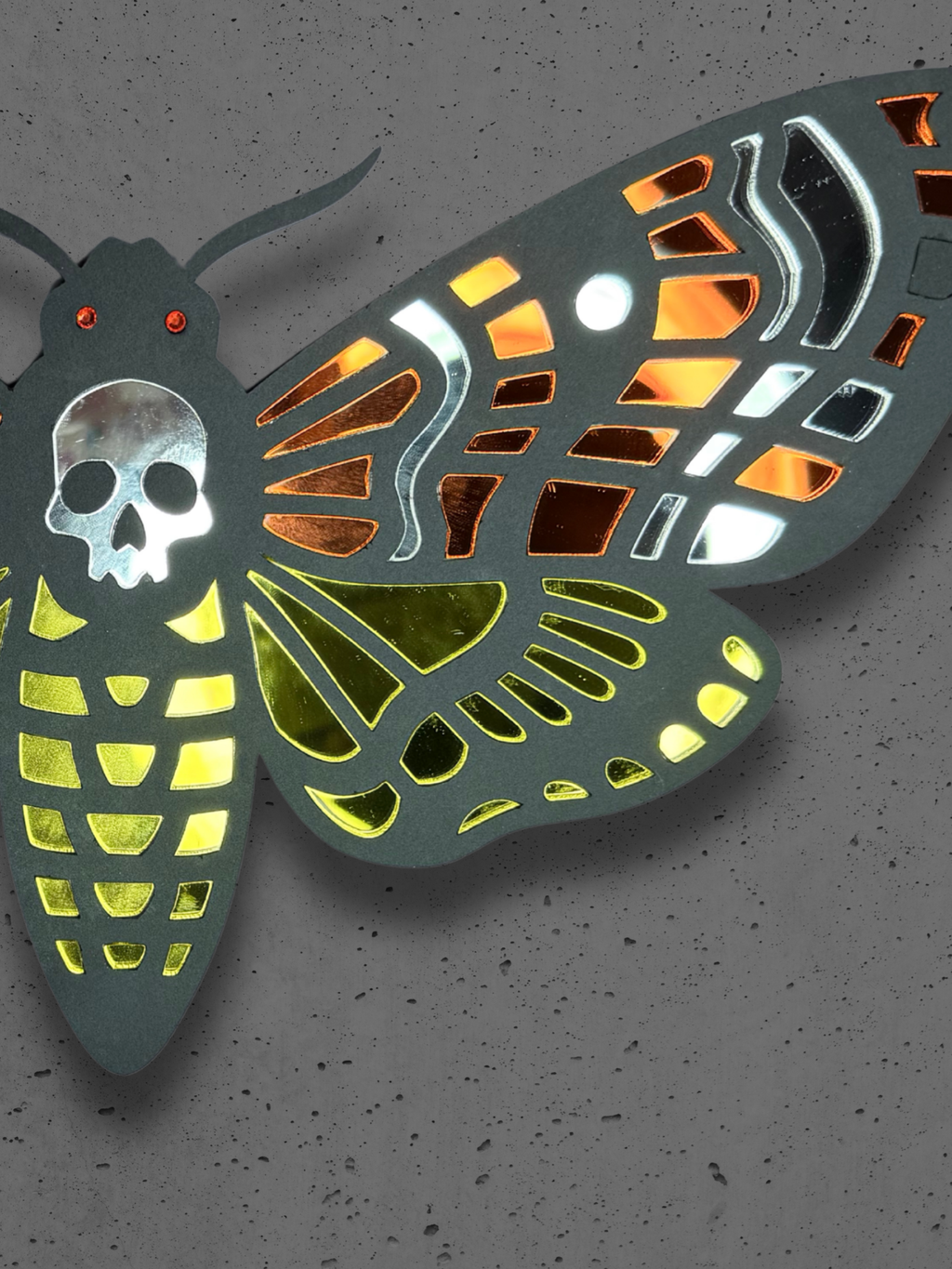 Mirrored moth wall art by Adorrible featuring a detailed, reflective moth design on a neutral background.